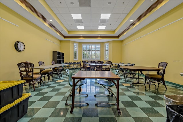 playroom featuring a tray ceiling, crown molding, and a drop ceiling