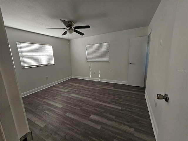 spare room with ceiling fan and dark hardwood / wood-style floors