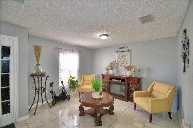 sitting room with light tile patterned flooring and a textured ceiling