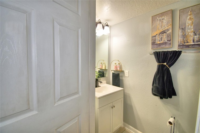 bathroom with vanity and a textured ceiling