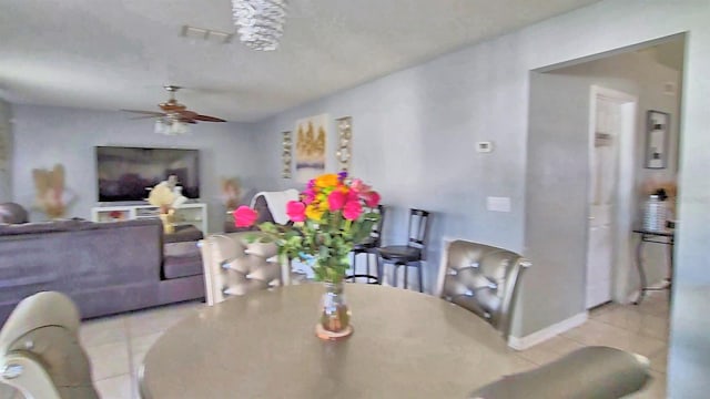 tiled dining room featuring ceiling fan