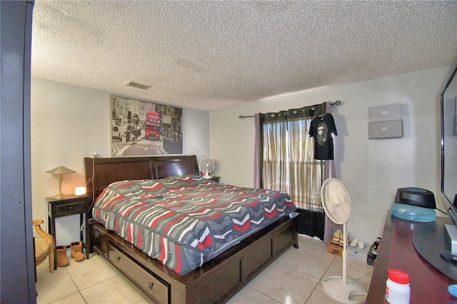 tiled bedroom featuring a textured ceiling