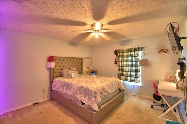 carpeted bedroom with ceiling fan and a textured ceiling