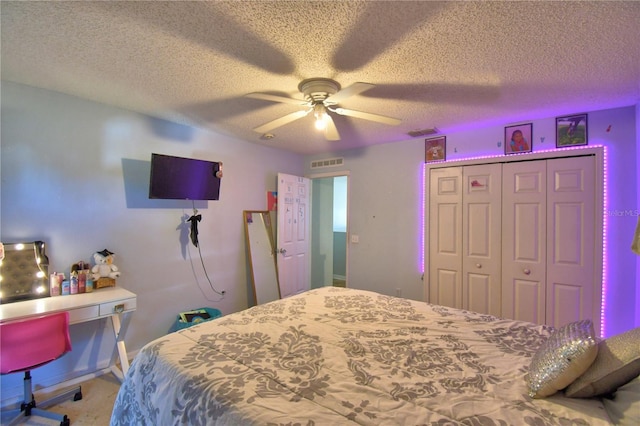 bedroom with ceiling fan, a closet, and a textured ceiling