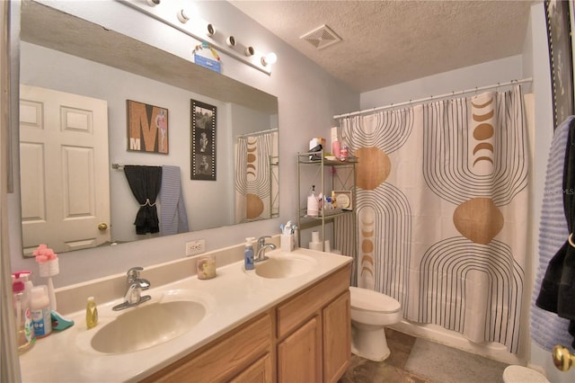 bathroom with a shower with shower curtain, vanity, toilet, and a textured ceiling