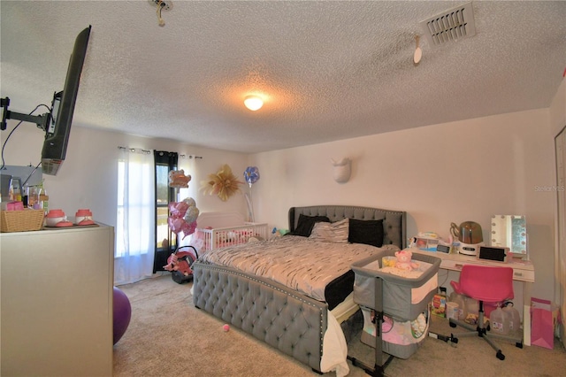 bedroom with light carpet and a textured ceiling