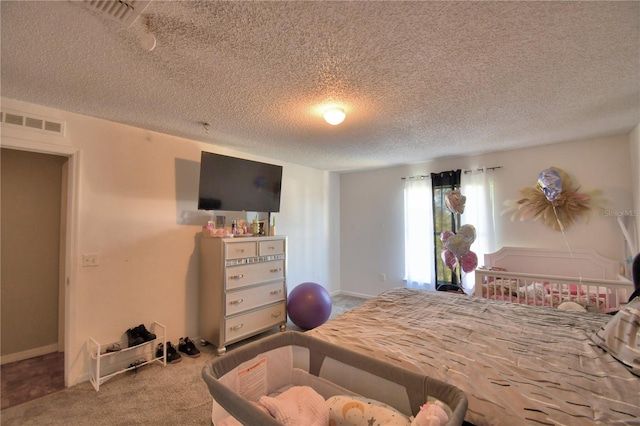 bedroom with carpet flooring and a textured ceiling