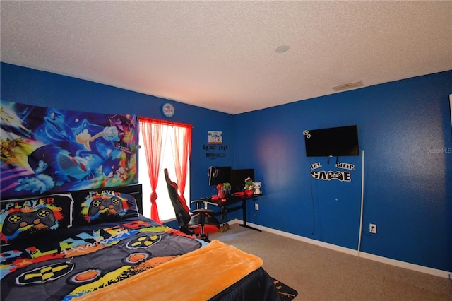 bedroom featuring carpet flooring and a textured ceiling