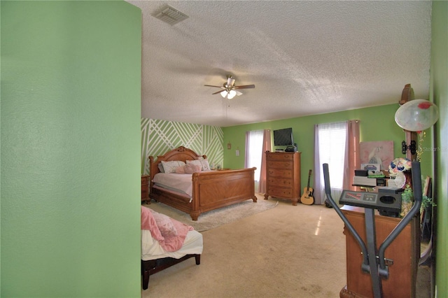 carpeted bedroom featuring a textured ceiling and ceiling fan