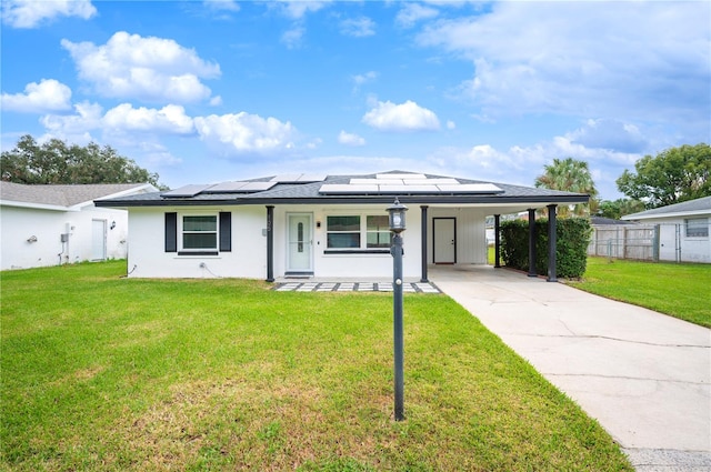 view of front facade with a front lawn, a carport, and a porch