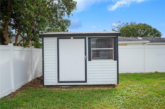 view of outdoor structure featuring a lawn