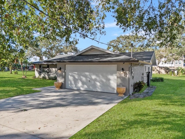 view of front of property with a front yard and a garage