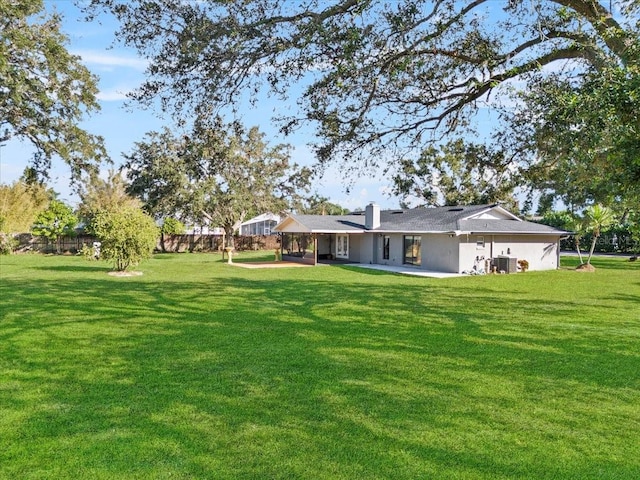 view of yard featuring cooling unit and a patio area