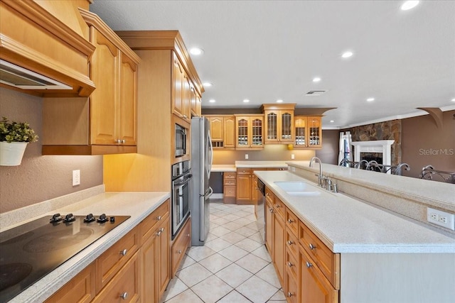 kitchen with sink, crown molding, light tile patterned floors, a fireplace, and stainless steel appliances