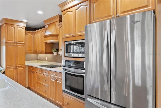 kitchen featuring sink, custom range hood, and stainless steel appliances