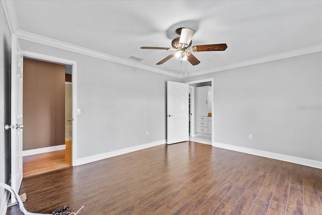 spare room featuring dark hardwood / wood-style floors and crown molding