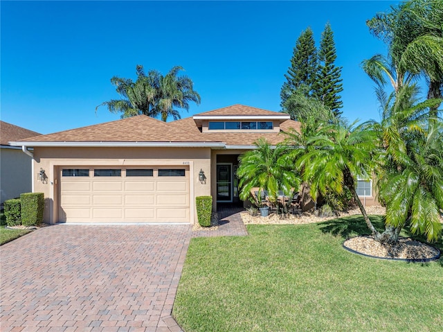 view of front of house with a garage and a front lawn