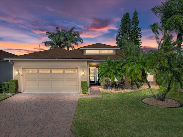 view of front of house with a lawn and a garage