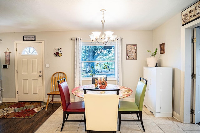 dining room featuring light hardwood / wood-style floors, plenty of natural light, and a notable chandelier