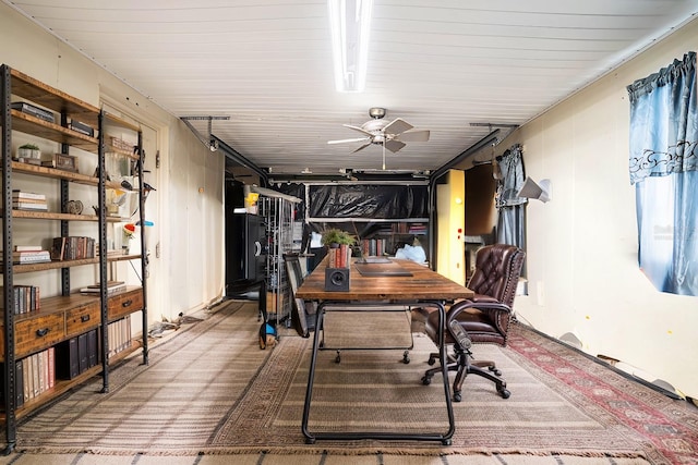 carpeted office space with ceiling fan