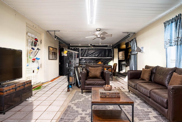 living room with tile patterned floors and ceiling fan