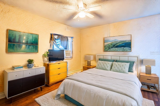 bedroom featuring ceiling fan, dark wood-type flooring, and a textured ceiling