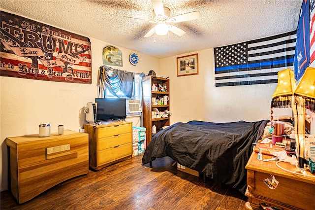 bedroom featuring a textured ceiling, dark hardwood / wood-style flooring, and ceiling fan