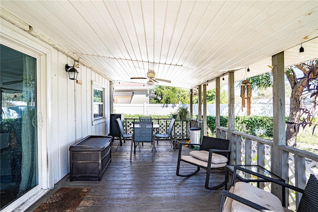 deck with ceiling fan and covered porch