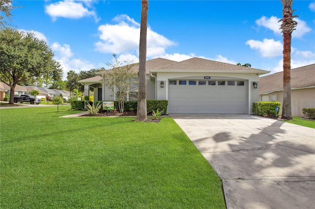 view of front of house with a front yard and a garage