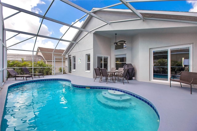 view of pool featuring ceiling fan, a patio area, and glass enclosure