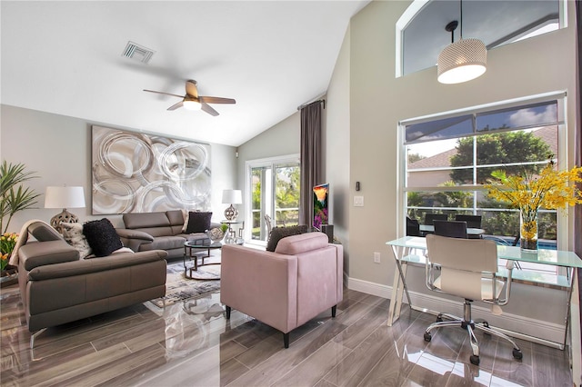 living room with ceiling fan, hardwood / wood-style floors, and vaulted ceiling