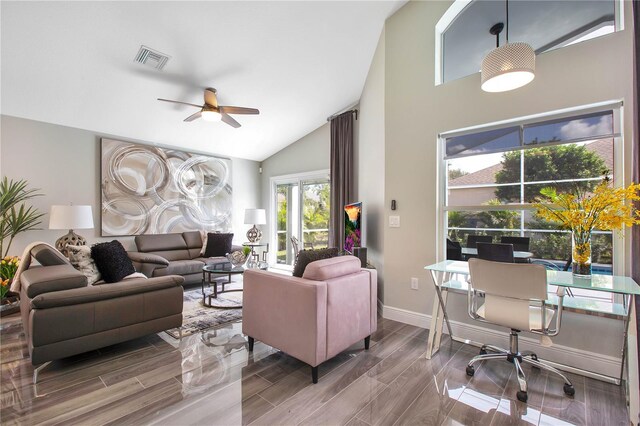 1591 Forest Hills Ln, Haines City, FL 33844 - living room with high vaulted ceiling, a ceiling fan, baseboards, and wood finish floors