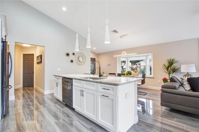 1591 Forest Hills Ln, Haines City, FL 33844 - kitchen with dishwasher, a sink, freestanding refrigerator, open floor plan, and light stone countertops