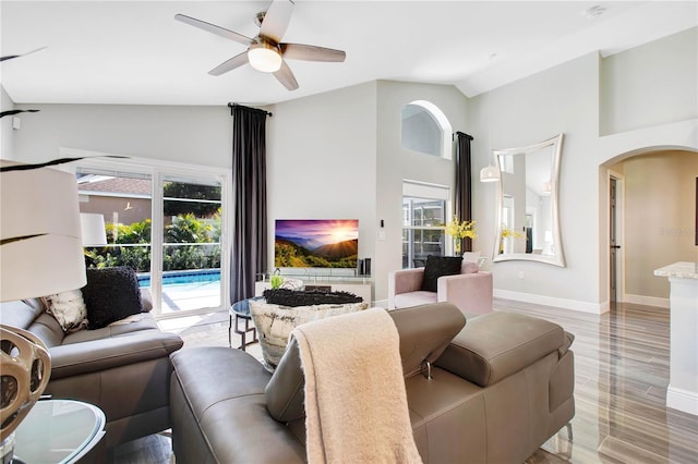 living room featuring high vaulted ceiling, light wood-type flooring, and ceiling fan