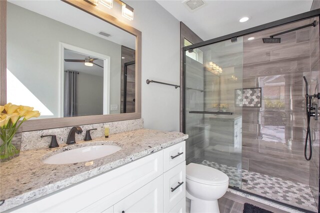 1591 Forest Hills Ln, Haines City, FL 33844 - full bath featuring vanity, toilet, a stall shower, recessed lighting, and a ceiling fan