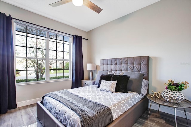 bedroom with wood-type flooring and ceiling fan