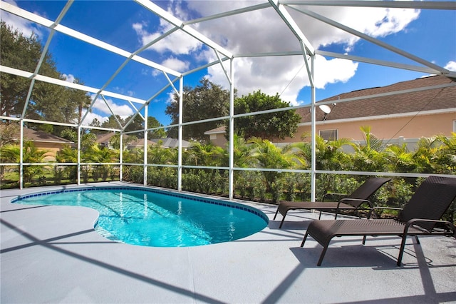 view of swimming pool with a lanai and a patio