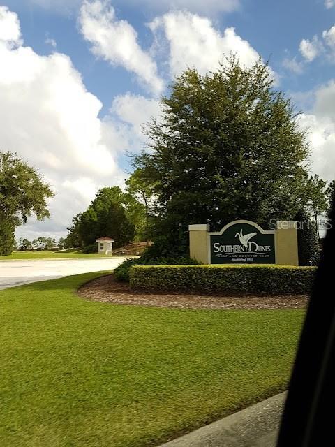 1591 Forest Hills Ln, Haines City, FL 33844 - community sign with a lawn and concrete driveway