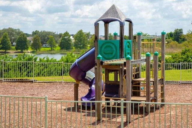 view of jungle gym featuring a water view