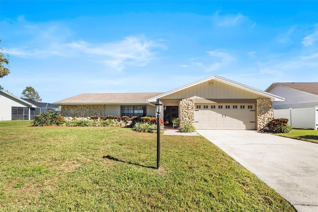 ranch-style home featuring a garage, driveway, stone siding, fence, and a front lawn