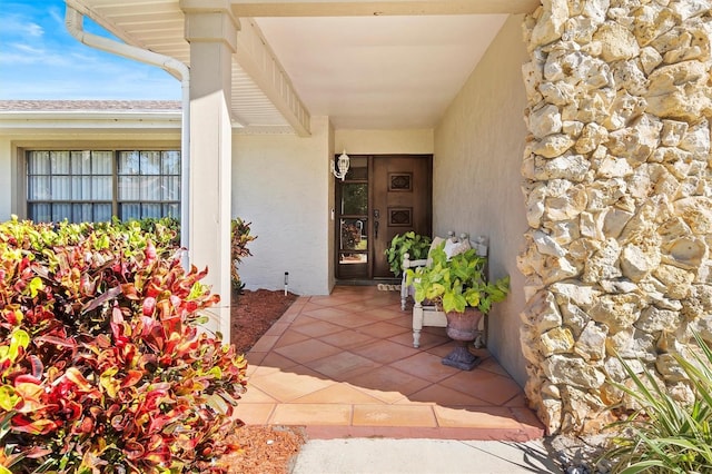 entrance to property with stucco siding