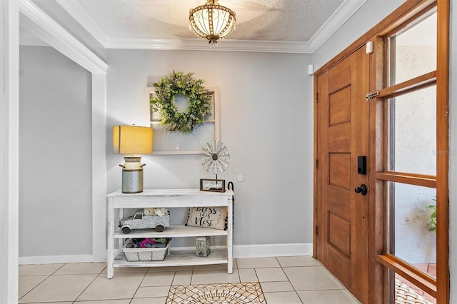 entryway featuring light tile patterned floors, a textured ceiling, baseboards, and crown molding