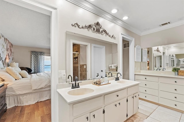 full bathroom featuring crown molding, visible vents, a sink, and double vanity