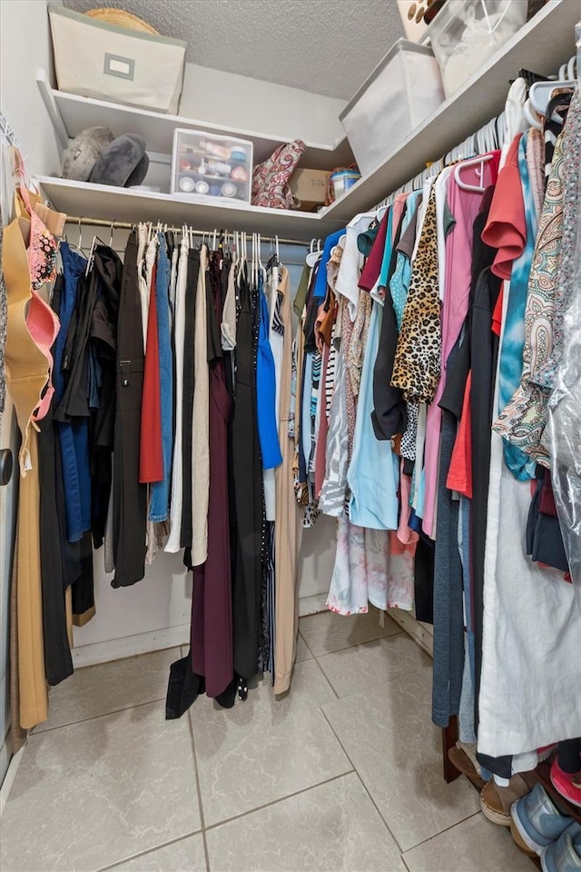 spacious closet with tile patterned floors