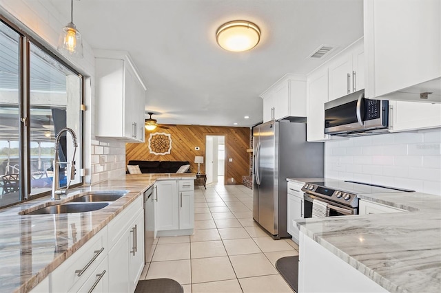 kitchen featuring appliances with stainless steel finishes, plenty of natural light, visible vents, and a sink