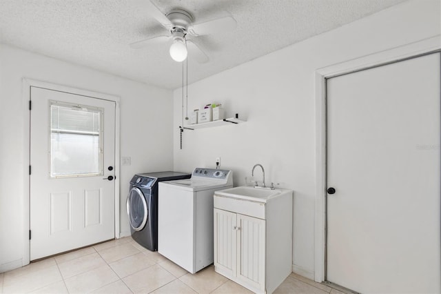 laundry area featuring ceiling fan, washer and clothes dryer, light tile patterned flooring, and a sink