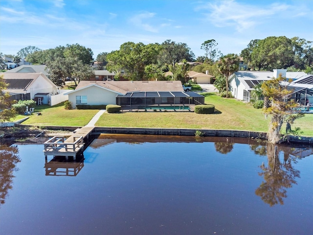 exterior space with a water view, glass enclosure, a residential view, and a lawn