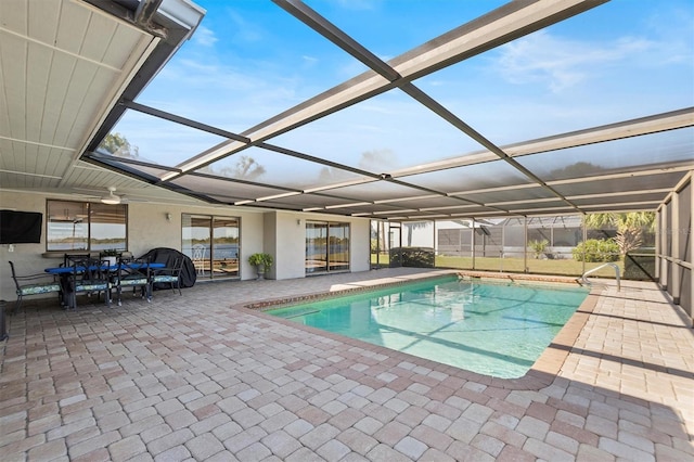 pool with a lanai and a patio