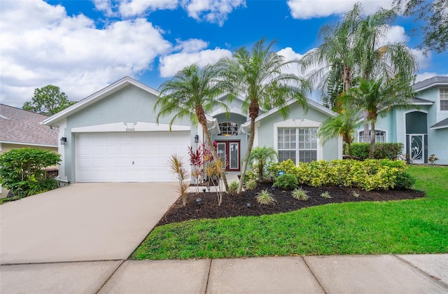 ranch-style home with a front lawn and a garage