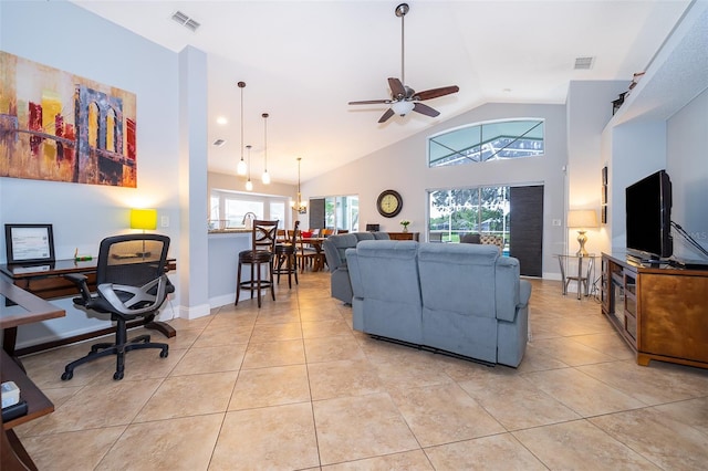 living room featuring ceiling fan with notable chandelier, a healthy amount of sunlight, light tile patterned floors, and high vaulted ceiling